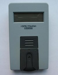 An older style portable blood glucose meter. A blood sample is applied to an inserted strip (see image below) and color changes caused by reaction with blood glucose are measured by the meter.